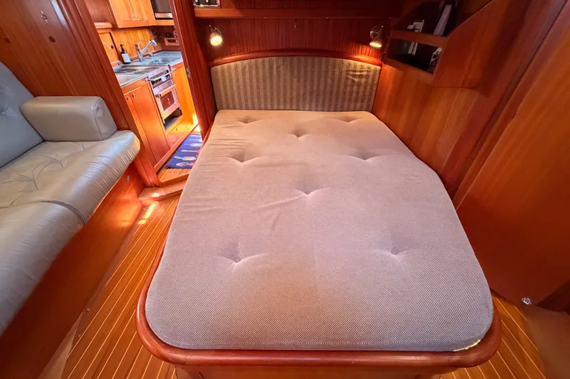 Slide: The Image of Interior of 2003 Farr 50 Pilot House yacht with cozy bed and wooden finish. - 120