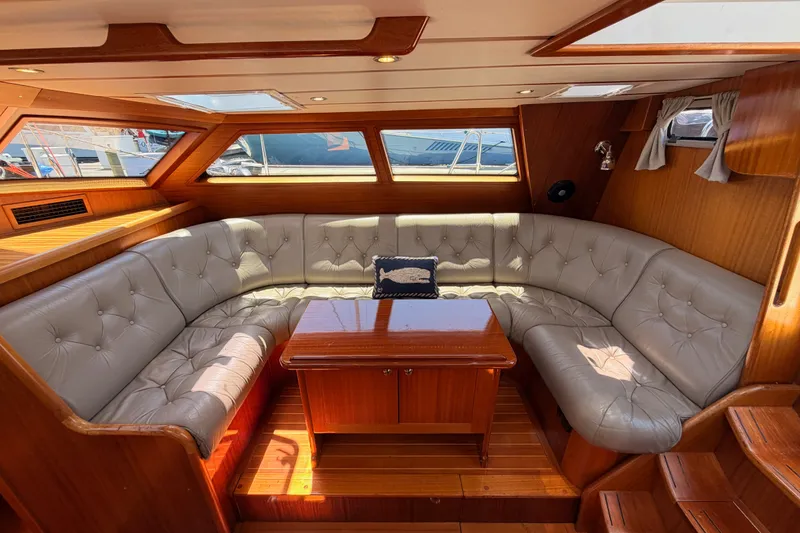 Slide: The Image of Luxurious interior of a 2003 Farr 50 Pilot House yacht with plush seating and wooden accents. - 58