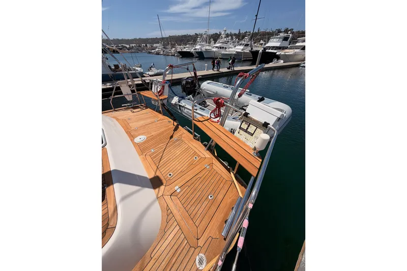 Slide: The Image of 2003 Farr 50 Pilot House yacht with wooden deck, docked at marina with other boats. - 42