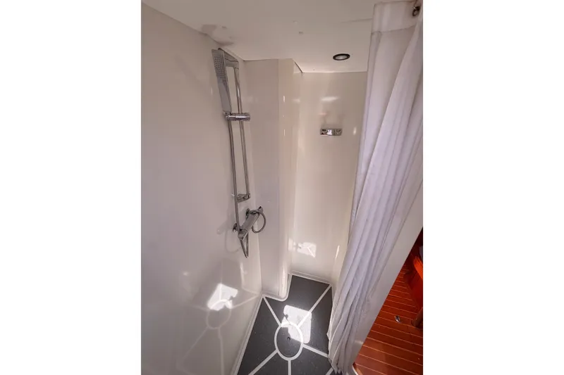 Slide: The Image of Shower area in 2003 Farr 50 Pilot House yacht with modern fixtures and curtain. - 90