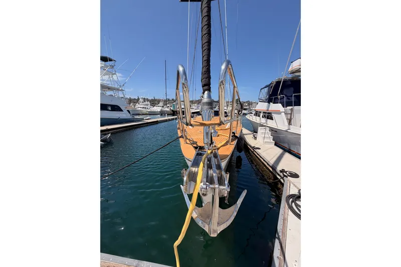 Slide: The Image of 2003 Farr 50 Pilot House yacht docked at marina, featuring sleek design and sturdy anchor. - 12