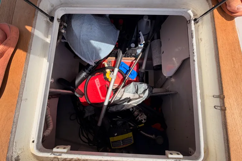 Slide: The Image of Storage compartment of a 2003 Farr 50 Pilot House yacht, containing various equipment and supplies. - 133