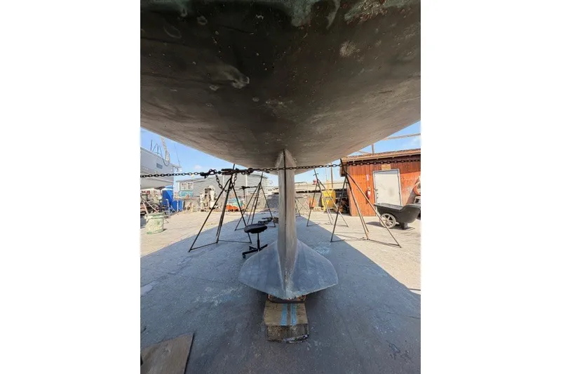 Slide: The Image of Underneath view of a 2003 Farr 50 Pilot House sailboat in a shipyard. - 144