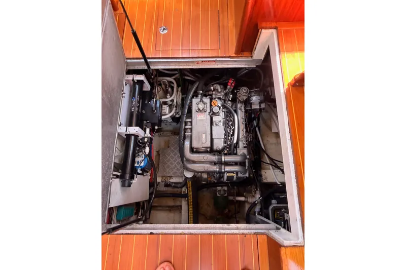 Slide: The Image of Engine compartment of a 2003 Farr 50 Pilot House yacht, showcasing mechanical components. - 132