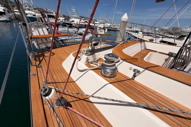 Slide: The Image of 2003 Farr 50 Pilot House yacht deck with wooden finish, docked at marina. - 35