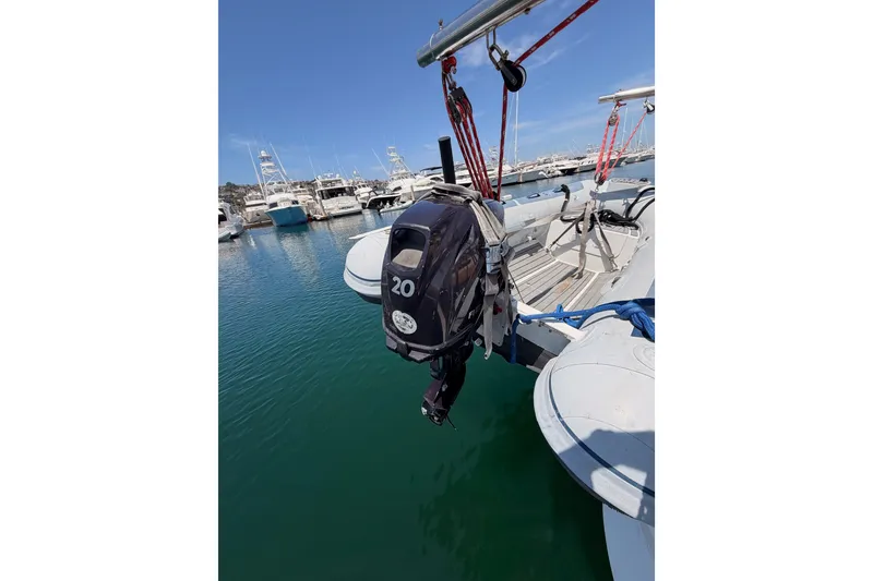 Slide: The Image of Outboard motor on a 2003 Farr 50 Pilot House yacht docked in a marina. - 39