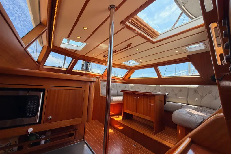 Slide: The Image of Luxurious interior of 2003 Farr 50 Pilot House yacht with wood finish and skylights. - 123