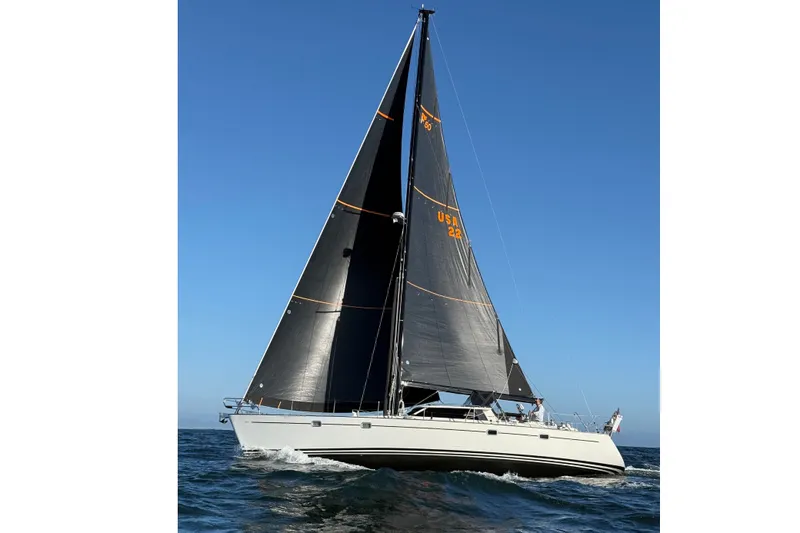 Slide: The Image of Sailing yacht Farr 50 Pilot House 2003 on open sea with black sails. - 2