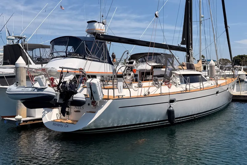 Slide: The Image of 2003 Farr 50 Pilot House yacht docked in marina under clear blue sky. - 7