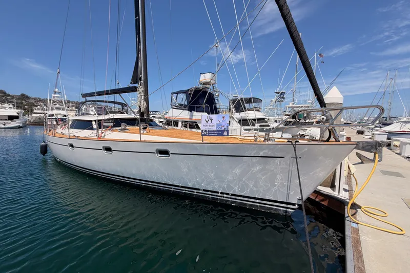 Slide: The Image of 2003 Farr 50 Pilot House yacht docked at marina under clear blue sky. - 10
