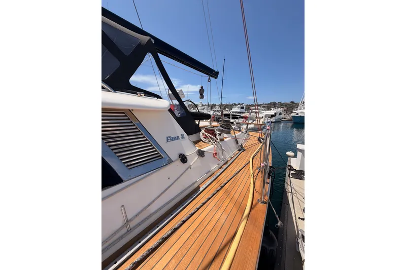 Slide: The Image of 2003 Farr 50 Pilot House yacht docked at marina, showcasing sleek deck design. - 19