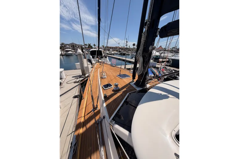 Slide: The Image of 2003 Farr 50 Pilot House sailboat docked at marina, showcasing teak deck and rigging. - 21