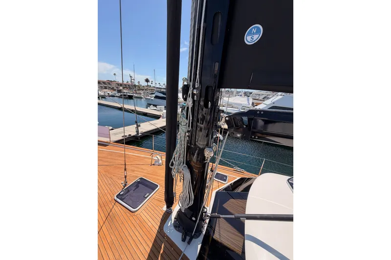 Slide: The Image of 2003 Farr 50 Pilot House sailboat deck with mast and rigging in marina. - 22