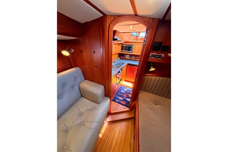 Slide: The Image of Interior of 2003 Farr 50 Pilot House yacht, featuring cozy seating and a well-equipped kitchen. - 121
