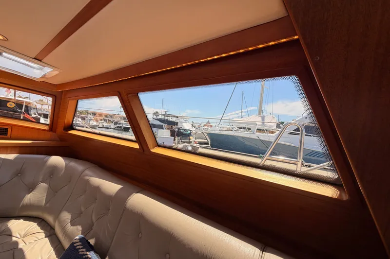 Slide: The Image of Interior view of 2003 Farr 50 Pilot House yacht with marina in background. - 60