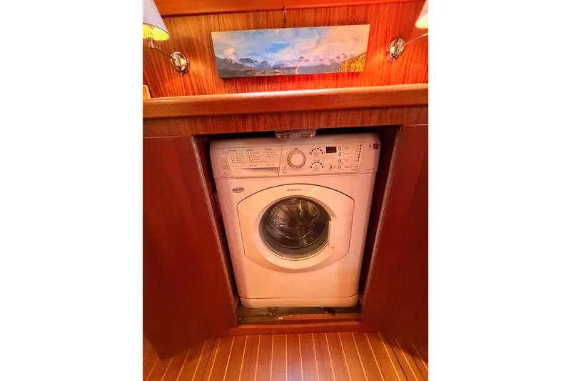 Slide: The Image of Washing machine in 2003 Farr 50 Pilot House yacht's wooden interior. - 111