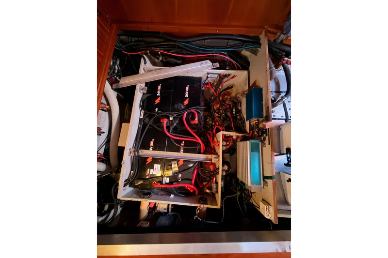 Slide: The Image of Electrical system of a 2003 Farr 50 Pilot House yacht, featuring batteries and wiring. - 138
