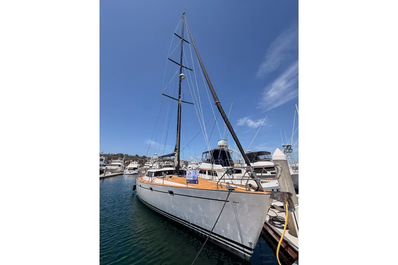 Slide: The Image of 2003 Farr 50 Pilot House sailboat docked in marina under clear blue sky. - 11