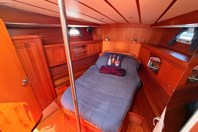 Slide: The Image of Cozy cabin interior of 2003 Farr 50 Pilot House yacht with wooden finish and comfortable bedding. - 93