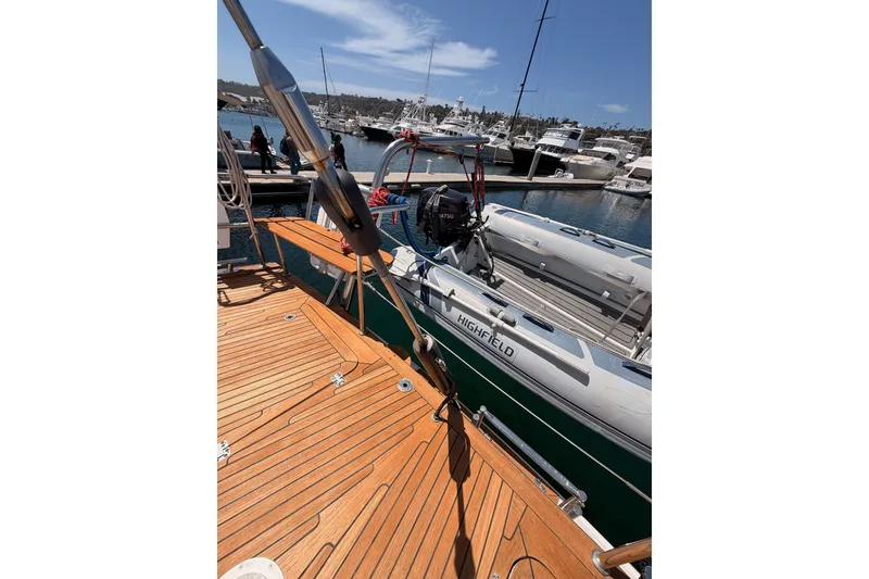 Slide: The Image of 2003 Farr 50 Pilot House yacht with wooden deck and docked inflatable boat. - 41