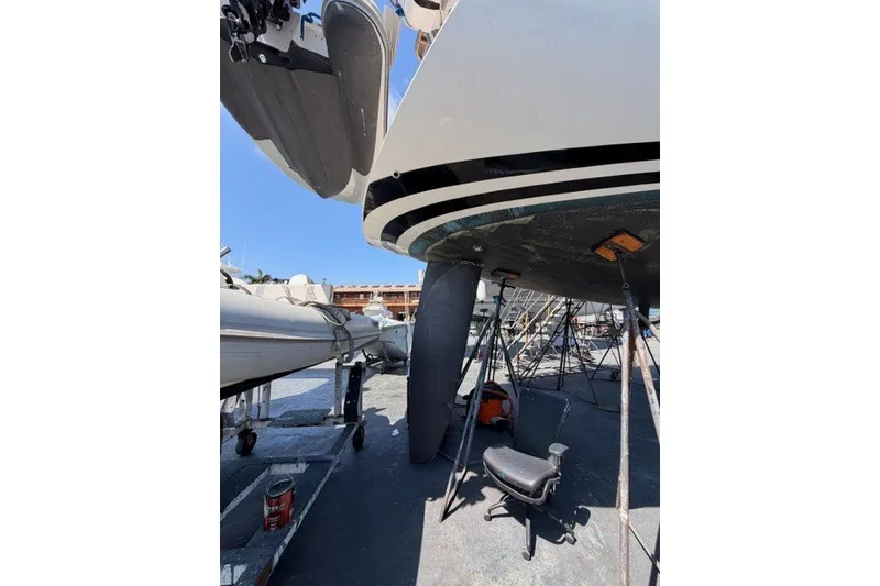 Slide: The Image of 2003 Farr 50 Pilot House yacht under maintenance, showing hull and keel in a boatyard. - 142
