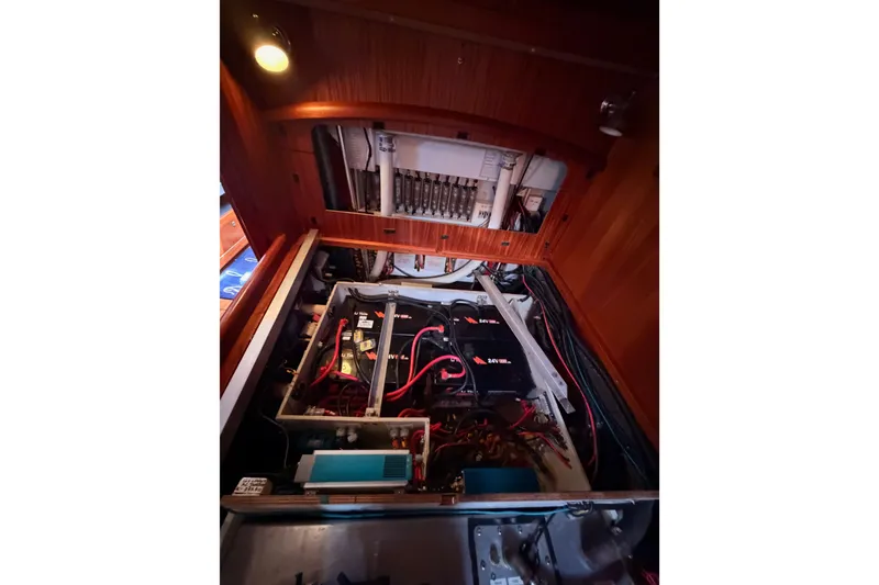 Slide: The Image of Engine room of 2003 Farr 50 Pilot House yacht, showcasing electrical components and wiring. - 139