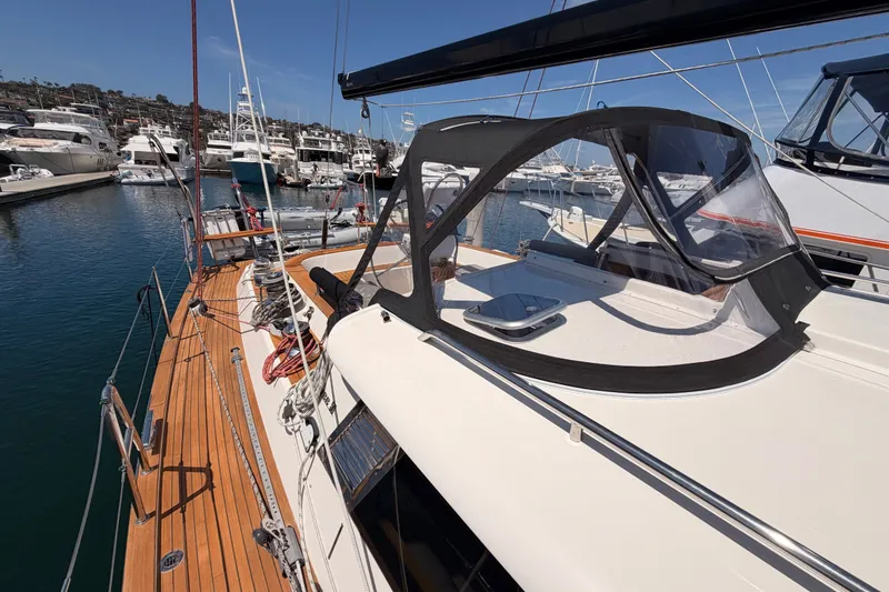 Slide: The Image of 2003 Farr 50 Pilot House yacht docked in a marina, showcasing sleek design and spacious deck. - 33