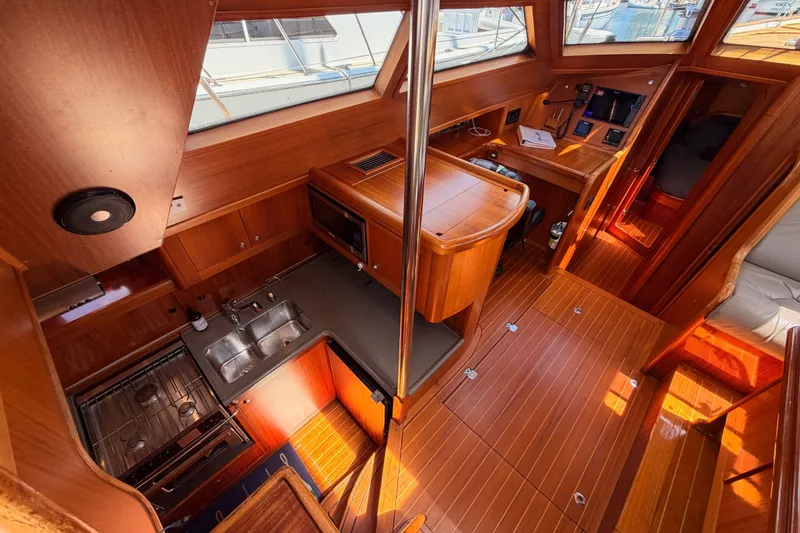 Slide: The Image of Interior of 2003 Farr 50 Pilot House yacht with wooden finishes and modern amenities. - 55
