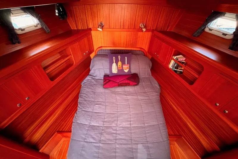 Slide: The Image of Luxurious 2003 Farr 50 Pilot House cabin with wood paneling and cozy bedding. - 84
