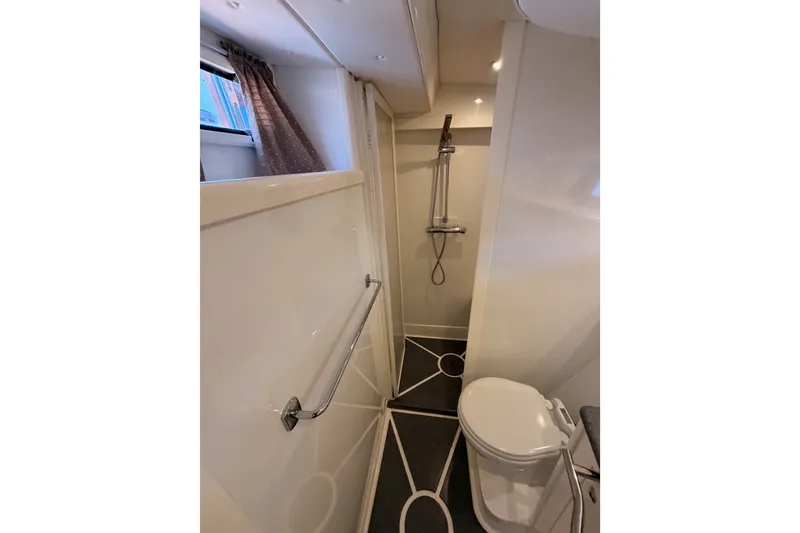 Slide: The Image of Bathroom interior of 2003 Farr 50 Pilot House yacht, featuring shower and toilet. - 114
