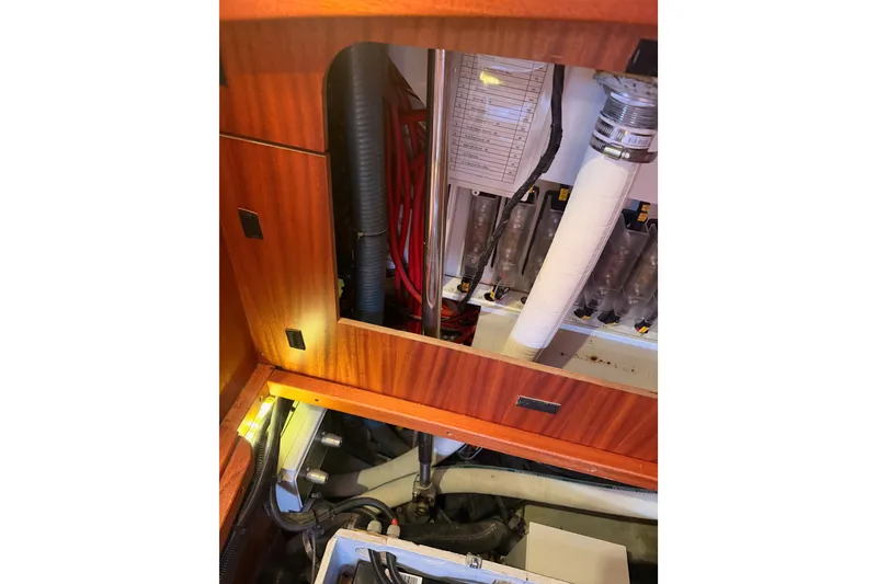 Slide: The Image of Engine compartment of a 2003 Farr 50 Pilot House yacht, showcasing wiring and components. - 137