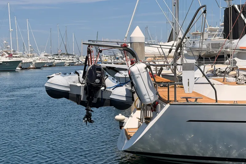 Slide: The Image of Farr 50 Pilot House 2003 yacht with dinghy at marina, surrounded by sailboats. - 9