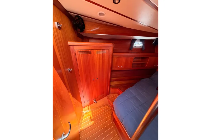 Slide: The Image of Interior of 2003 Farr 50 Pilot House with wooden cabinetry and cozy sleeping area. - 85