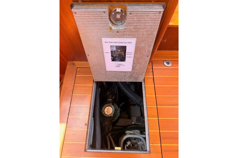 Slide: The Image of Open hatch on 2003 Farr 50 Pilot House, revealing engine compartment. - 127