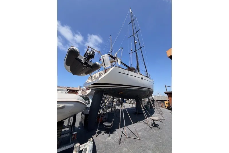 Slide: The Image of 2003 Farr 50 Pilot House sailboat on dry dock under clear blue sky. - 141