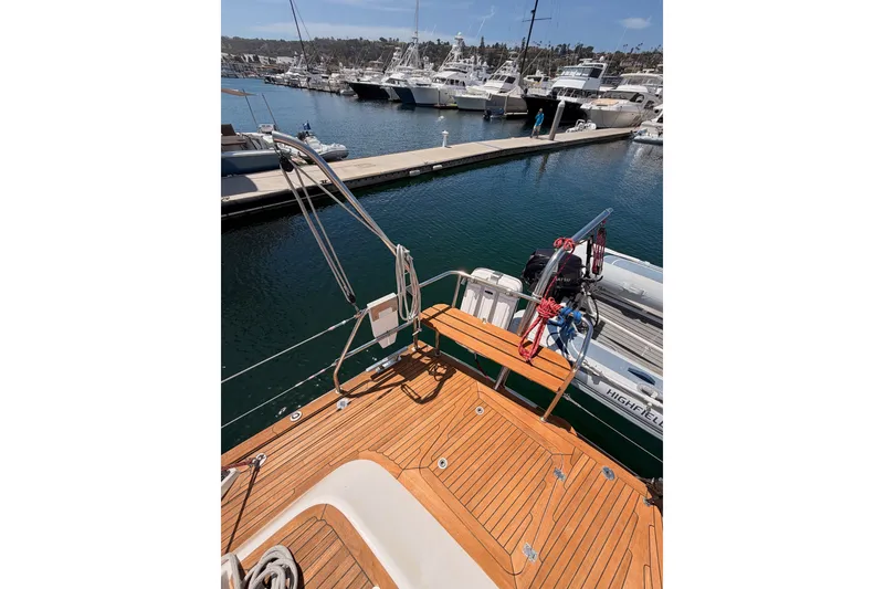 Slide: The Image of Deck view of 2003 Farr 50 Pilot House yacht in marina, with boats docked nearby. - 37