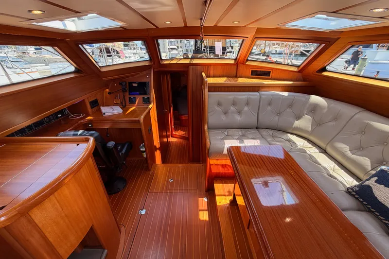 Slide: The Image of Luxurious 2003 Farr 50 Pilot House interior with wood finish and plush seating. - 57