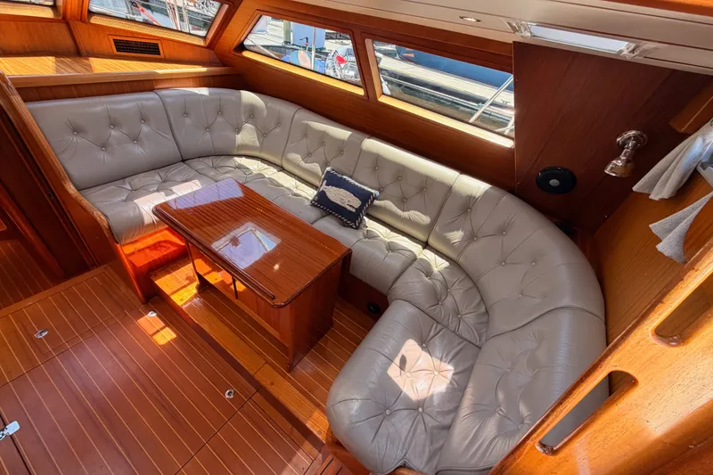 Slide: The Image of Luxurious interior of a 2003 Farr 50 Pilot House yacht with plush seating and wooden accents. - 56