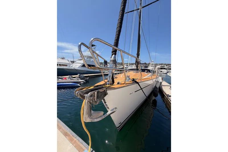Slide: The Image of 2003 Farr 50 Pilot House sailboat docked in marina under clear blue sky. - 13