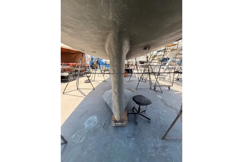 Slide: The Image of Underneath view of a 2003 Farr 50 Pilot House sailboat in dry dock. - 146