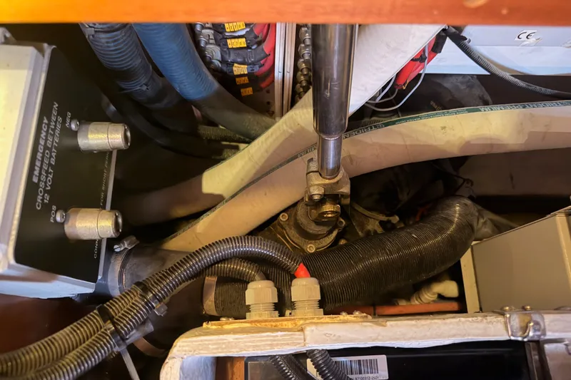Slide: The Image of Engine compartment of a 2003 Farr 50 Pilot House, showcasing wiring and mechanical components. - 136