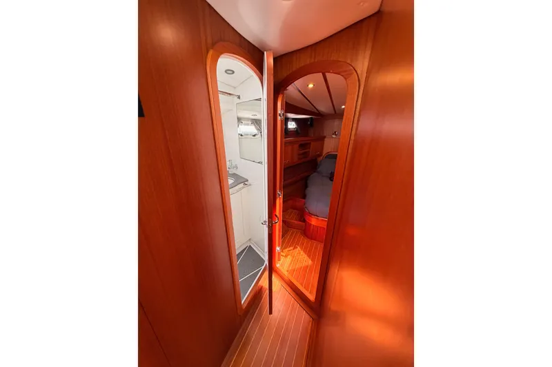 Slide: The Image of Interior view of 2003 Farr 50 Pilot House yacht, featuring wood paneling and cozy cabin space. - 79