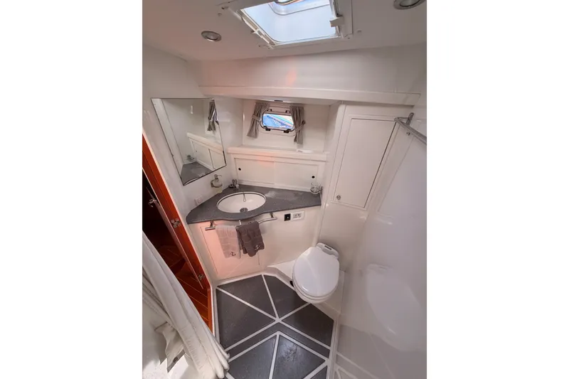 Slide: The Image of Bathroom interior of 2003 Farr 50 Pilot House yacht, featuring modern fixtures and skylight. - 91