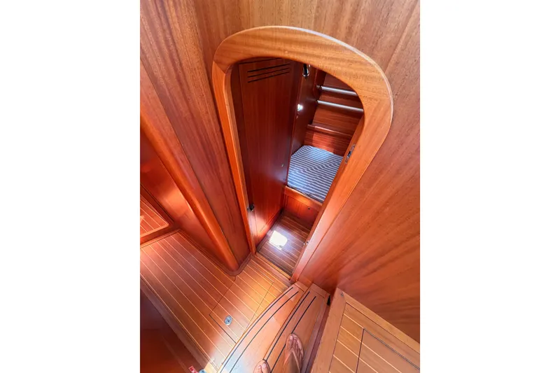 Slide: The Image of Interior view of 2003 Farr 50 Pilot House, showcasing wooden cabin and cozy sleeping area. - 74