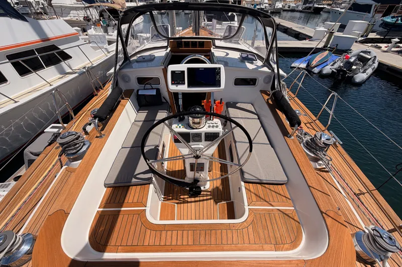 Slide: The Image of Cockpit of 2003 Farr 50 Pilot House yacht with wooden deck and navigation equipment. - 44