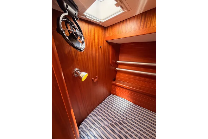 Slide: The Image of Cozy cabin interior of 2003 Farr 50 Pilot House yacht with striped bedding. - 77
