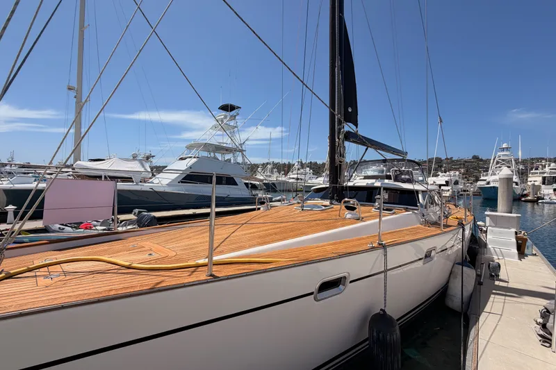 Slide: The Image of 2003 Farr 50 Pilot House yacht docked at marina under clear blue sky. - 15