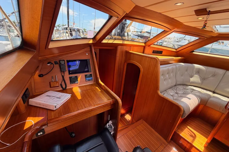 Slide: The Image of Luxurious interior of 2003 Farr 50 Pilot House yacht with wood finish and plush seating. - 72