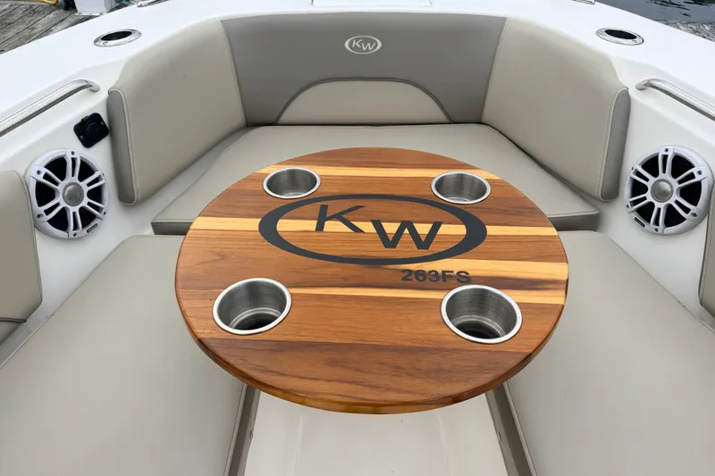 Slide: The Image of 2024 Key West 263 FS boat interior with wooden table and cup holders. - 12