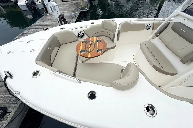 Slide: The Image of 2024 Key West 263 FS boat interior with seating and table at dock. - 26